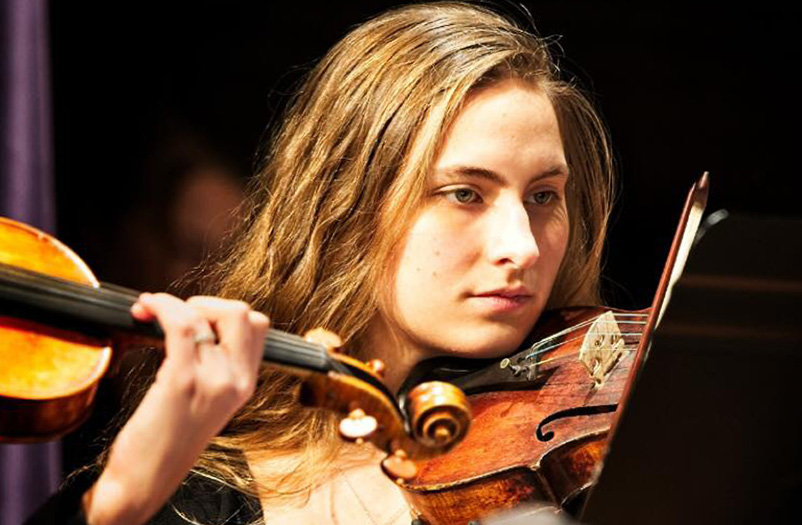 Young woman playing the violin